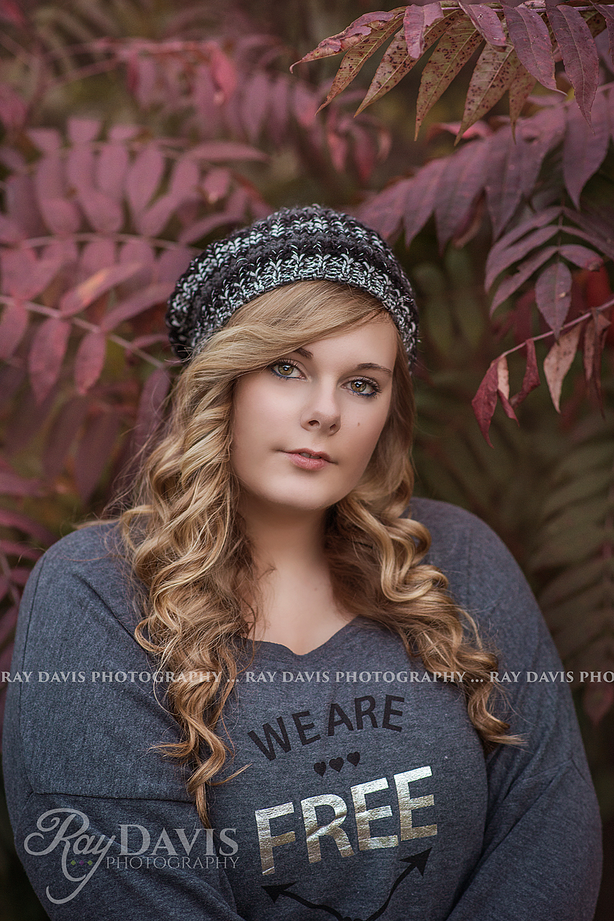 Plus Size High School Senior Picture of girl with long curly hair by Louisville Senior Photographer Ray Davis