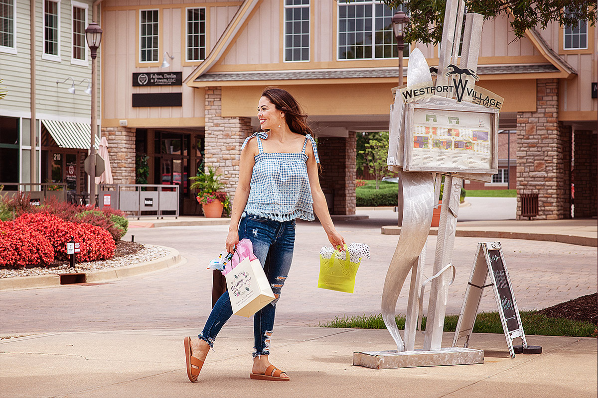 Westport Village Shopping Center with Girl with bags by Branding Photographer