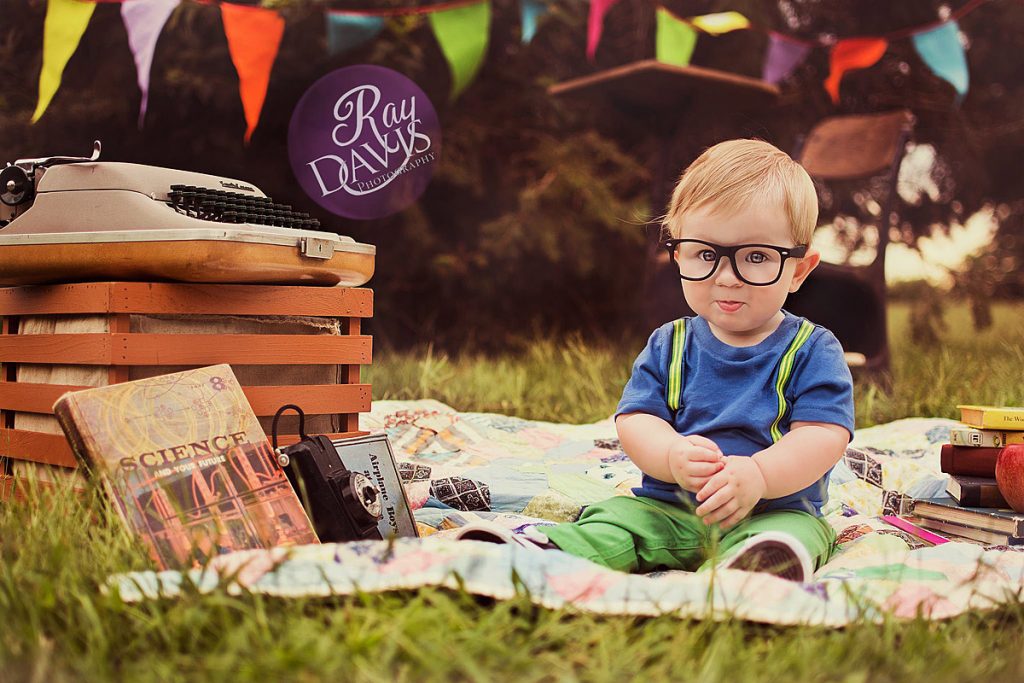 Back To School Mini Session with cute kid in glasses by a typewriter taken by Louisville Photographer Ray Davis