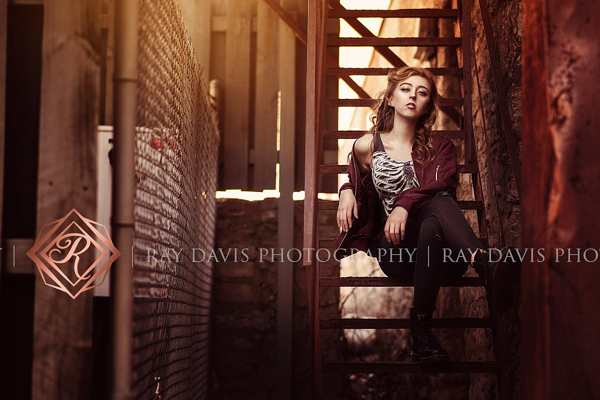 Urban Street style girl sitting on metal stair in downtown for Louisville Senior Pictures with Ray Davis Photography