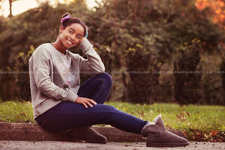 girl sitting on ground with twin buns hairstyle for 10 year old pictures