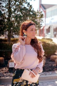 Woman touching flower earrings from Collections Boutique taken by Louisville Social Content Photographer