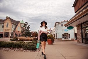 Woman with shopping bag in Westport Village from collections Boutique in cute trendy outfit for social media content photography