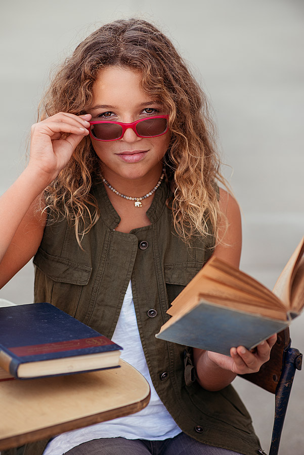 Tween Girl with Textbook holding glasses from Louisville Photographers Back To School Mini Session