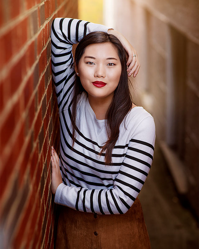 Senior Picture of Asian girl in striped shirt in downtown for Louisville Senior Pictues