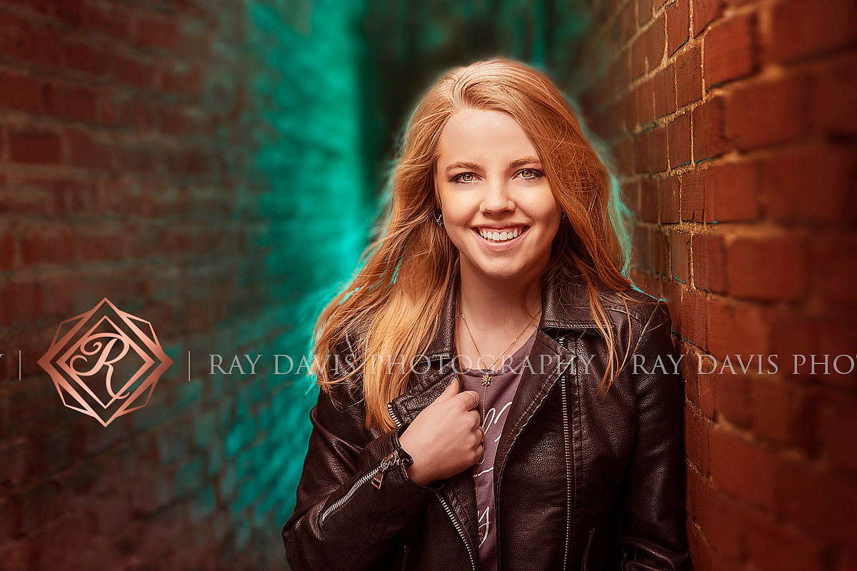 Blonde senior girl in alley way with off camera flash in urban lagrange taken by louisville photographer Ray Davis Photography