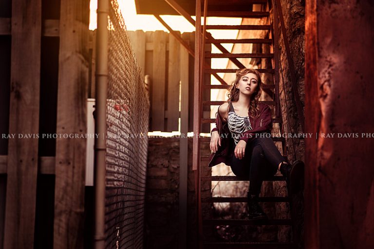 Urban Street style girl sitting on metal stair in downtown for Louisville Senior Pictures with Ray Davis Photography