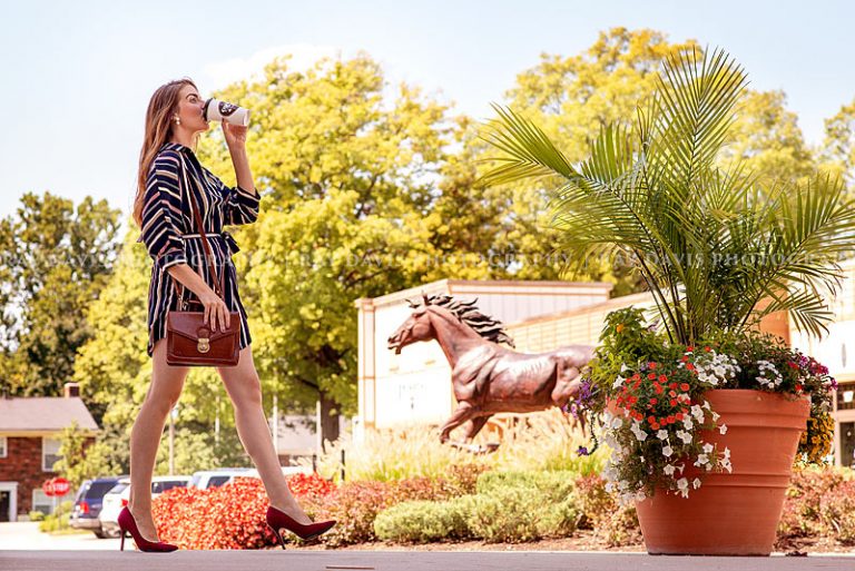 Instagram Influencer The Blush Influence drinking coffee while walking through Westport Village