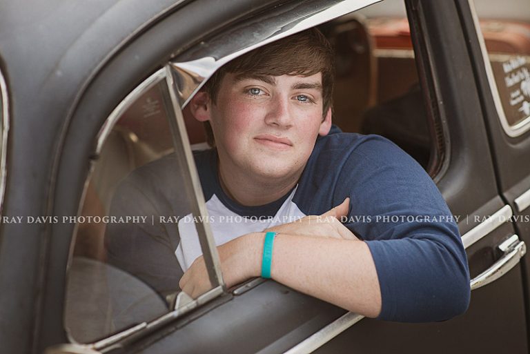 Oldham high school senior guy posed in car window taken by Louisville Photographer