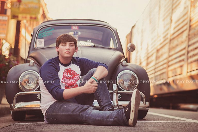 oldham county high school senior in from of VW beetle taken by Ray Davis Photography