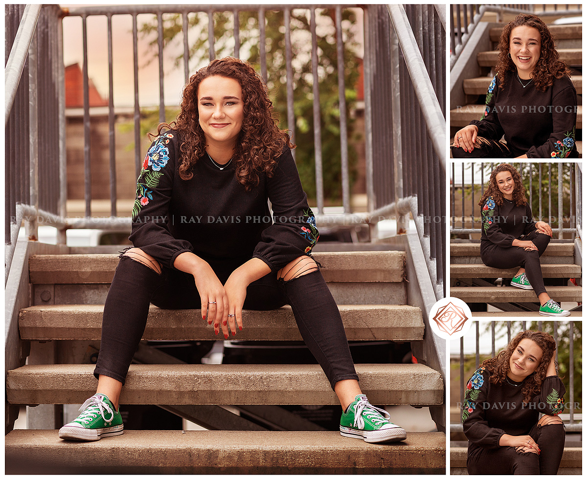 Curly Haired girl sitting on steps in downtown Louisville for Senior Pictures