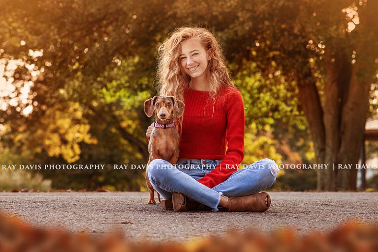 Louisville senior girl sitting on ground with dog taken by Ray Davis Photography